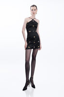 Black ZULEMA mini dress by LEDIEL, featuring a fitted silhouette and stylish short sleeves, displayed on a mannequin.