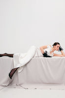 Ivory long-silhouette floral appliqué sheath maxi dress by Malva Florea displayed on a model.