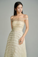 Beige off-shoulder organza gown by HAPPY CLOTHING from the CULT MIA X collection, featuring elegant flowing fabric and stylish design.