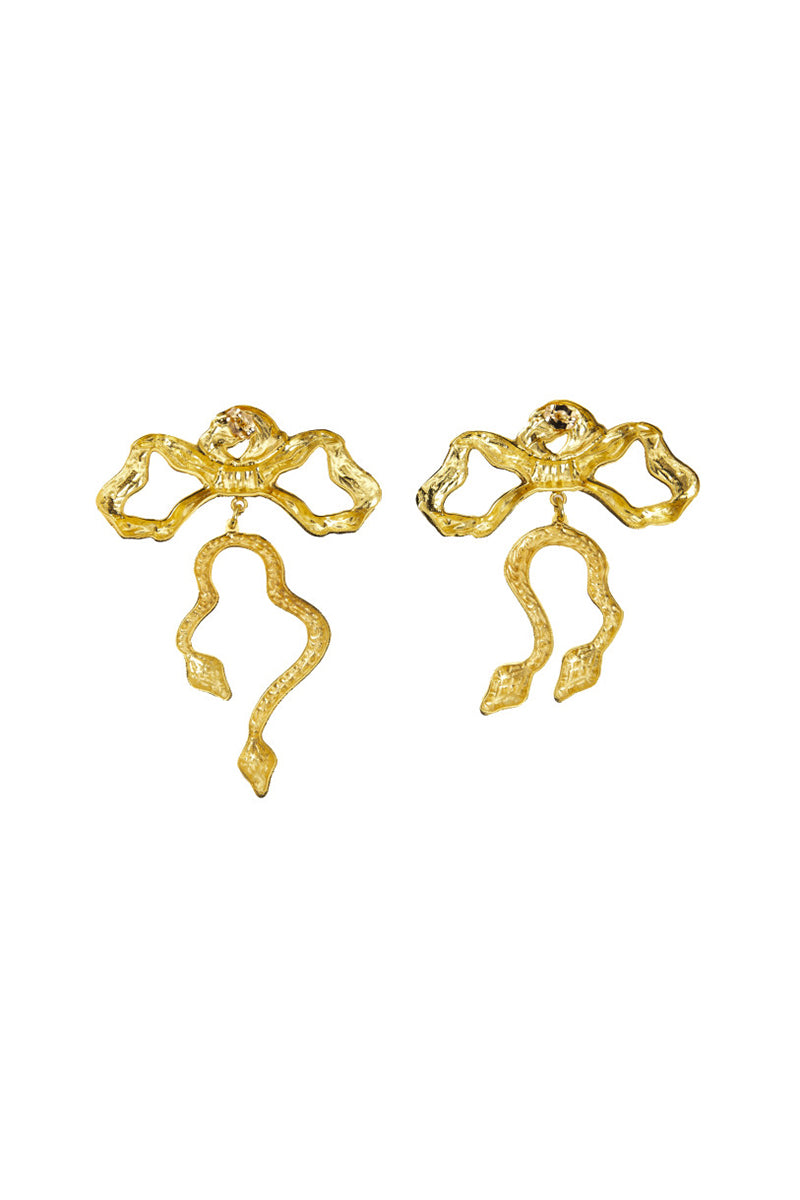Natia x Lako bow earrings featuring asymmetric snake designs, showcasing elegant gold-tone earrings with intricate snake motifs.