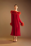 Red Valenciani midi dress with ostrich feather trim and pleated design, showcasing elegant, flowing fabric and stylish details.