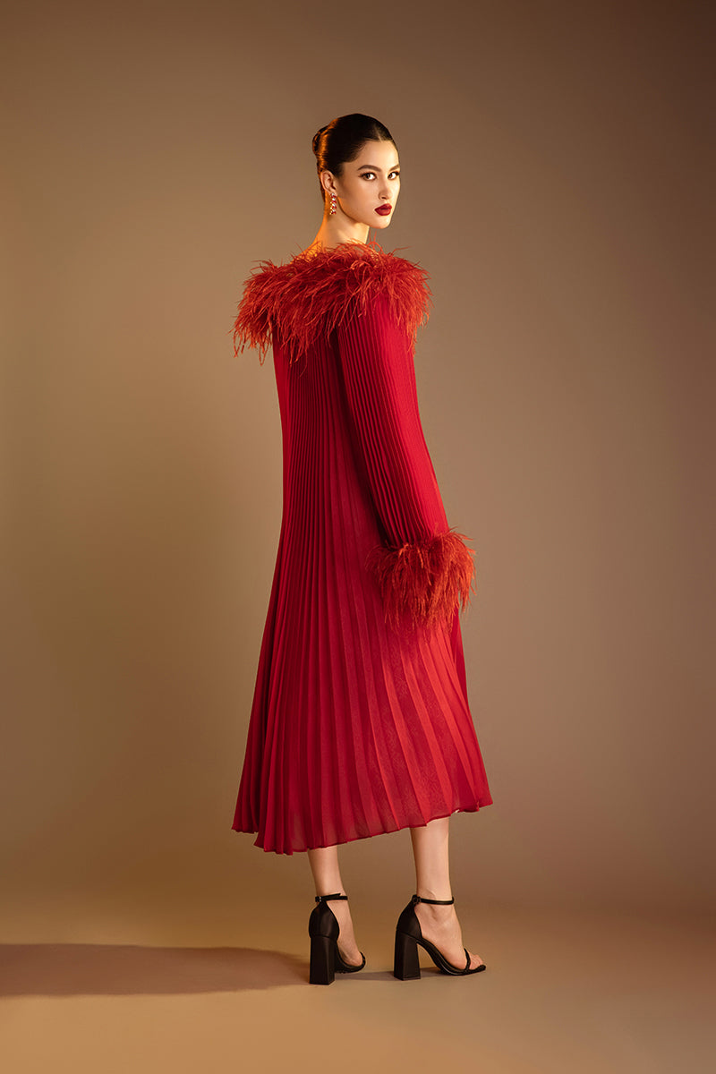 Red Valenciani midi dress with ostrich feather trim and pleated design, showcasing elegant fabric and stylish silhouette.