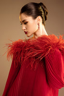 Red Valenciani midi dress with ostrich feather trim and pleated design, elegant evening dress with stylish details.