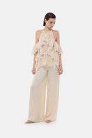 Montsand ivory wide-leg trousers laid flat, showcasing their relaxed fit and smooth fabric for a stylish, comfortable look.
