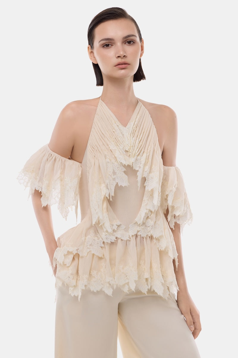 Ivory ruffled halter top by Montsand, featuring soft fabric, ruffle details, and a stylish halter neckline, perfect for summer wear.