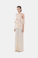 Ivory wide-leg trousers by Montsand, featuring a relaxed fit and high waist, shown on a model against a neutral background.