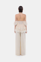 Ivory ruffled halter top by Montsand, featuring layered ruffle details and a stylish halter neckline, perfect for summer outfits.