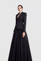 Black taffeta mikado peplum gown by Tracy Studio, showcasing a sleek, elegant dress with a fitted bodice and flared peplum detail.