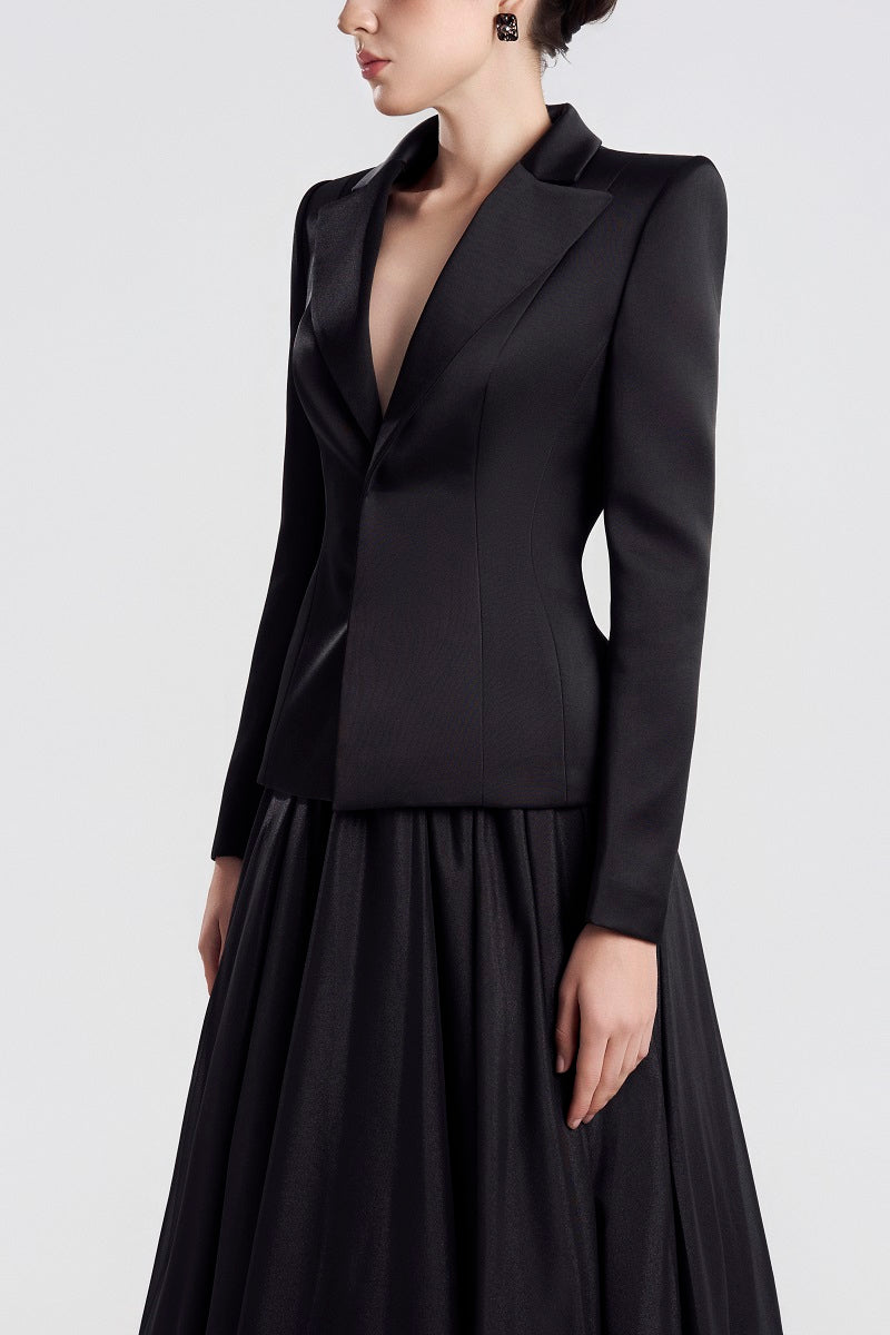 Black taffeta mikado peplum maxi dress by Tracy Studio, shown on a model, featuring elegant peplum detail and flowing silhouette.
