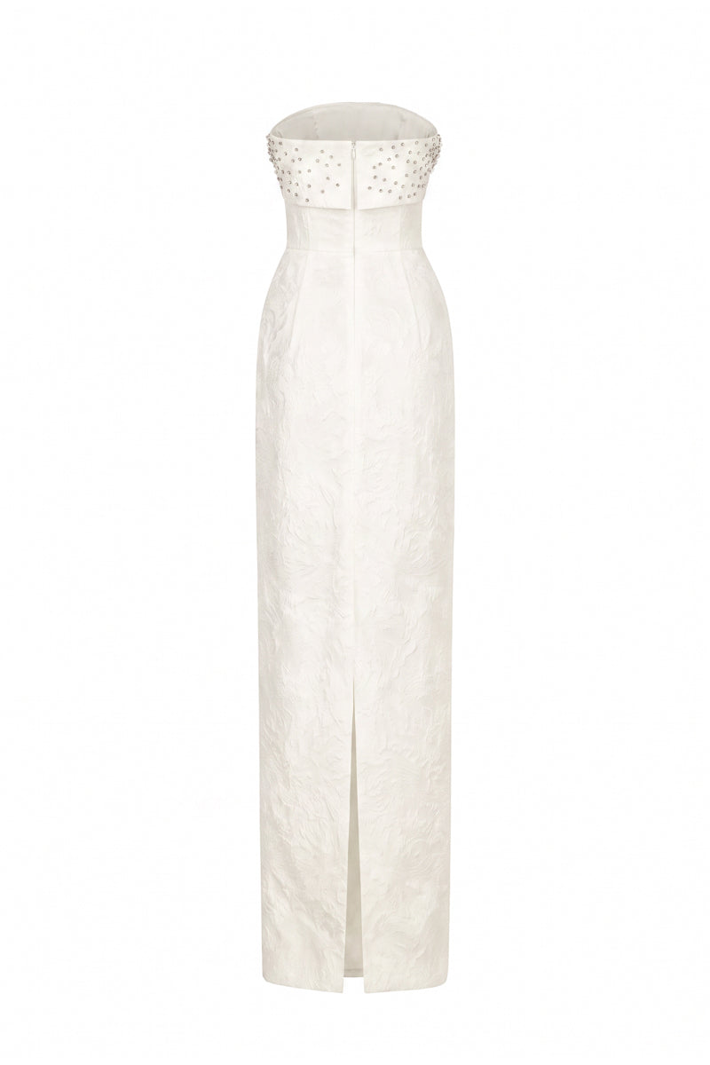 White strapless ballgown in rose design brocade by I.H.F, featuring intricate floral patterns and elegant flowing fabric.