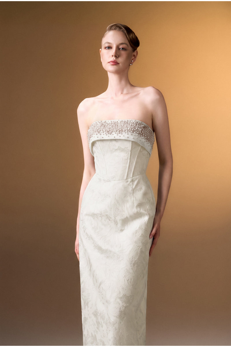 White strapless ballgown in rose brocade design by I.H.F, featuring elegant floral embroidery and a fitted bodice.