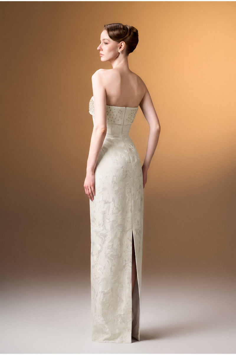 Elegant white strapless ballgown in rose design brocade, by I.H.F, featuring intricate floral embroidery and a flowing silhouette.