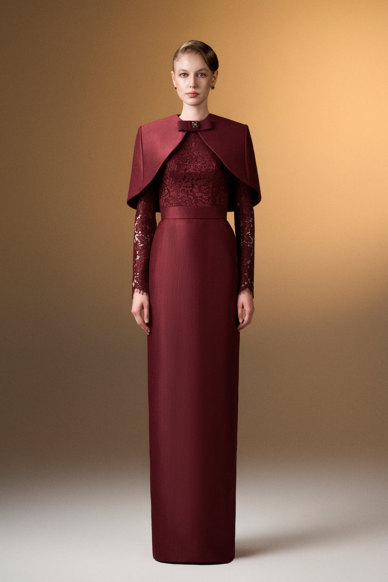 Dark red I.H.F gown with round neck, long sleeves, and a matching mini cape, elegant formal evening wear.