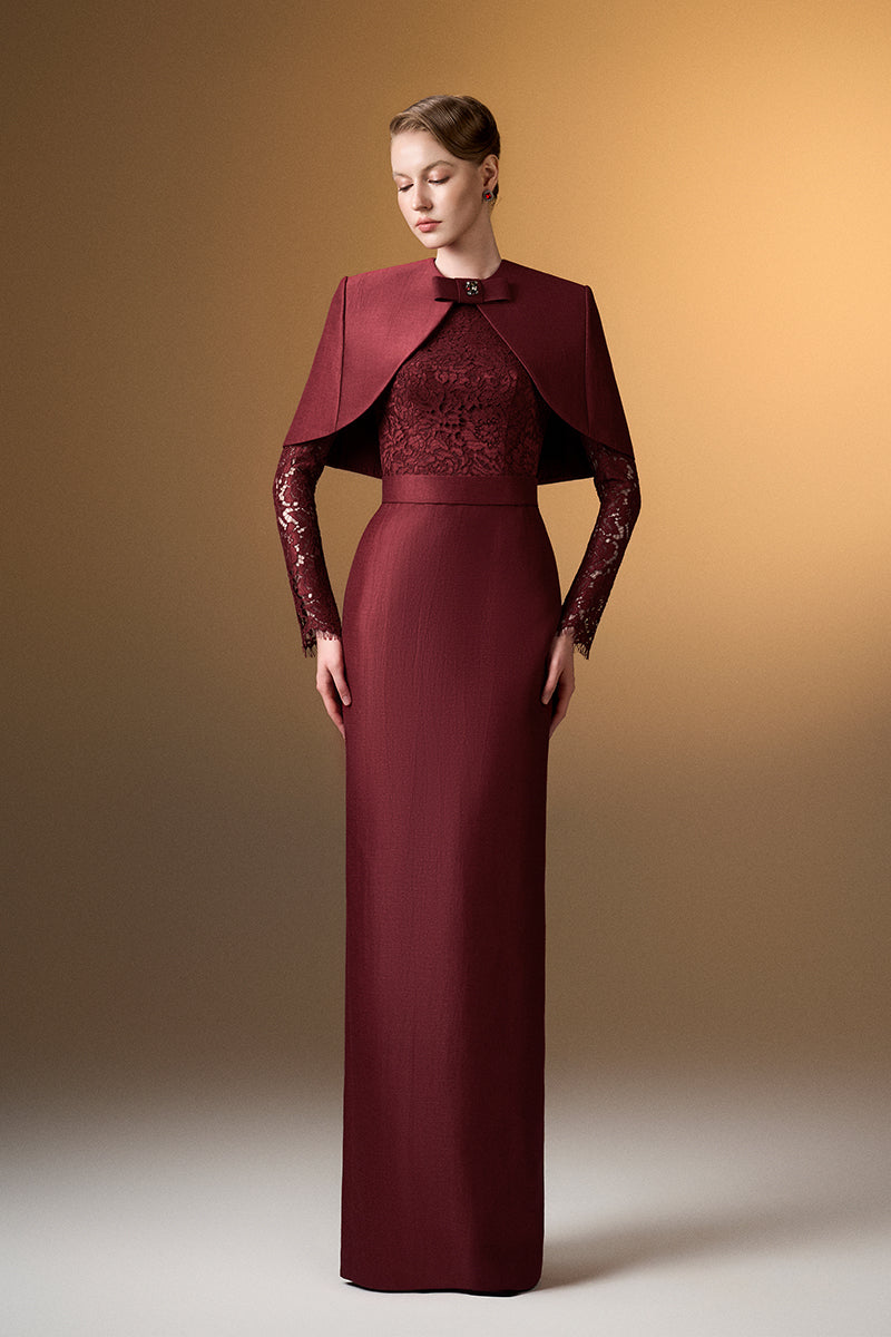 Dark red I.H.F gown with a round neck, long sleeves, and a stylish mini cape, designed for elegant occasions.