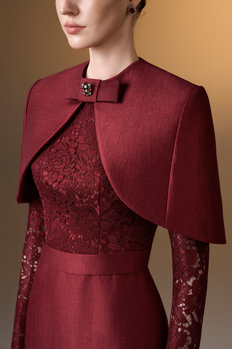 Dark red I.H.F gown with round neckline, long sleeves, and a stylish mini cape, perfect for elegant occasions.