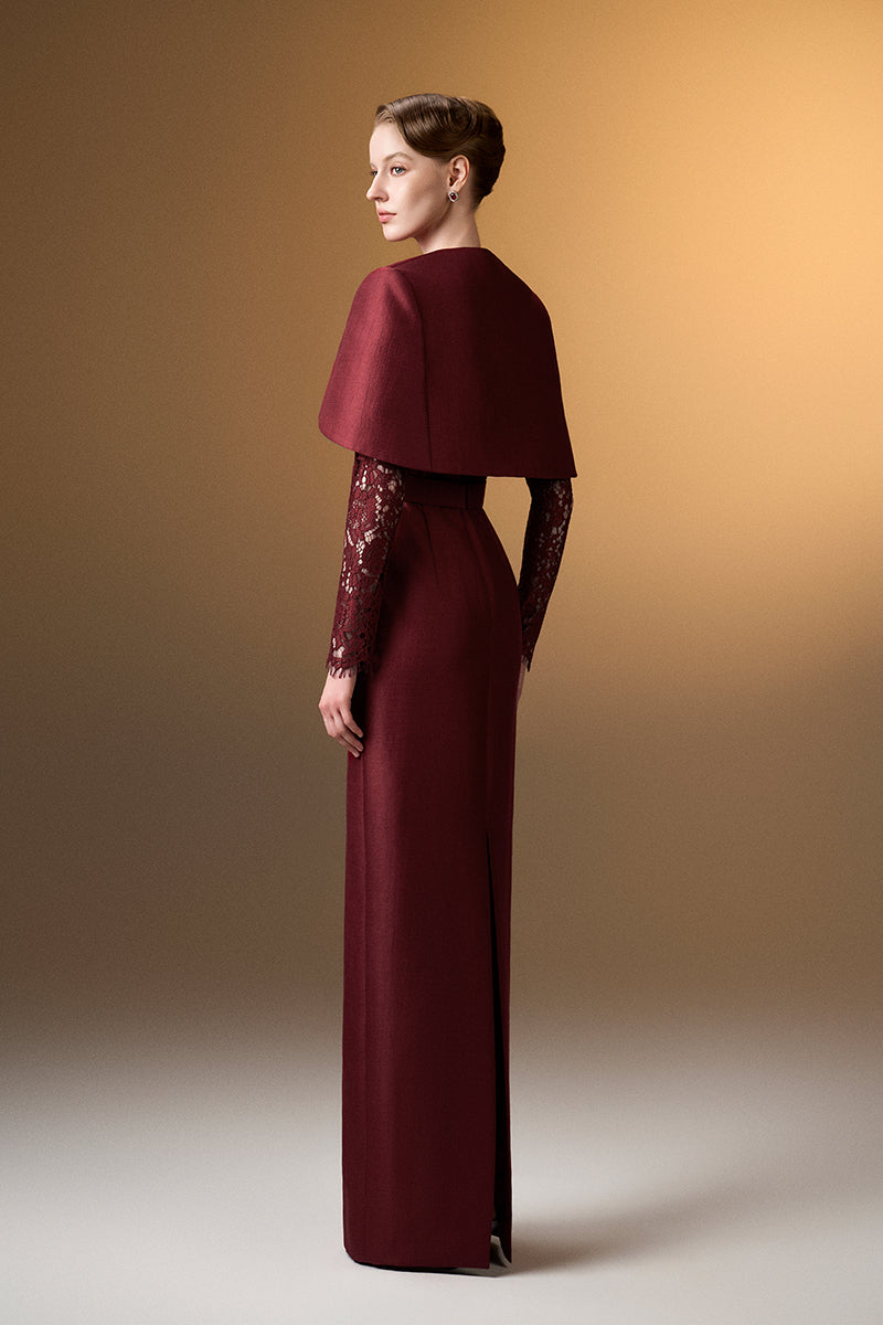 Dark red I.H.F gown with round neck, long sleeves, and a mini cape, featuring a sleek column design for elegant occasions.