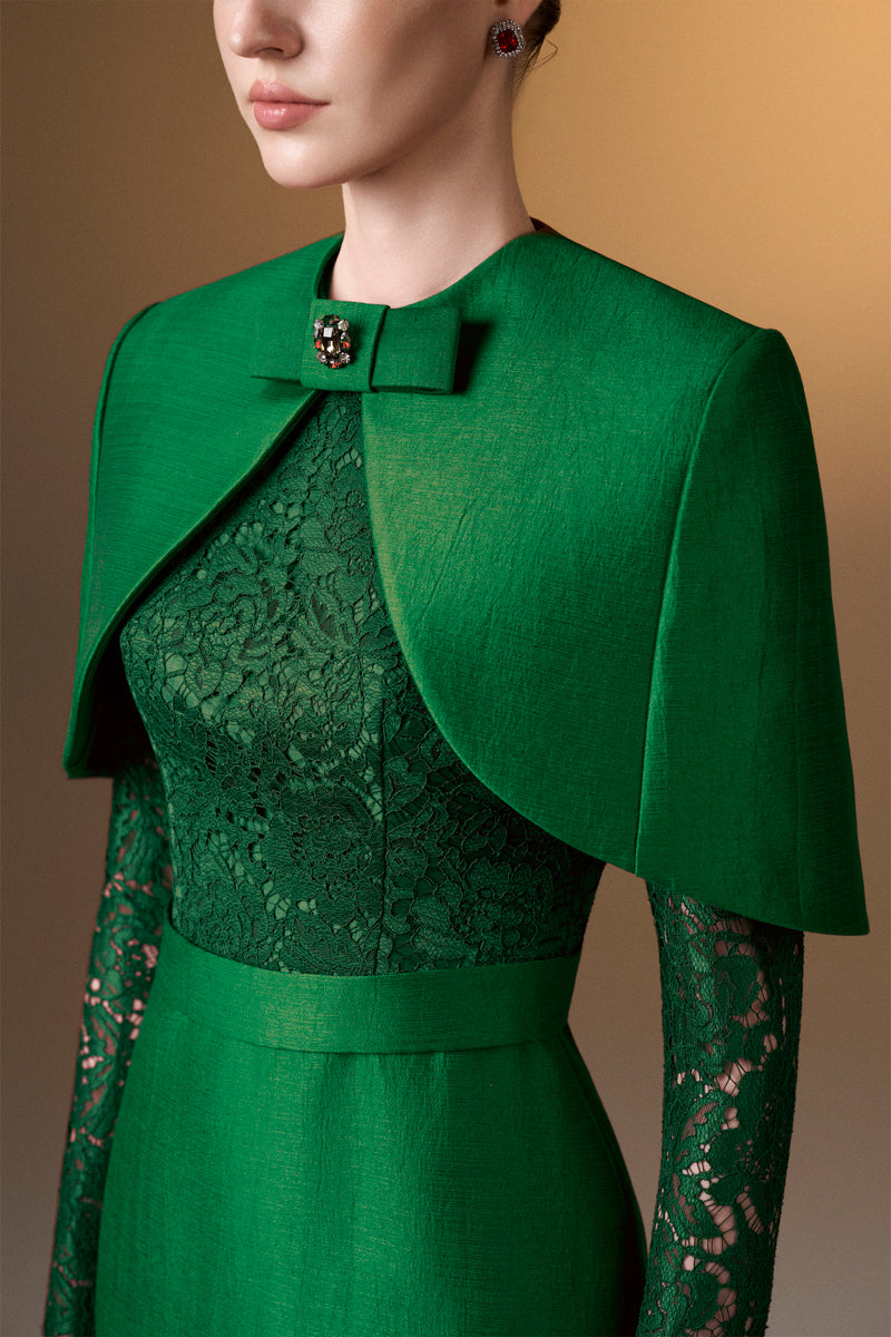 Green I.H.F gown with round neck, long sleeves, and a mini cape, featuring a sleek, elegant design.