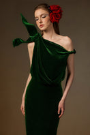 Dark green velvet one-shoulder gown with asymmetric design and flowing drape, by I.H.F, perfect for formal occasions.