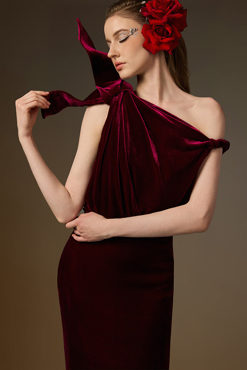 Dark pink velvet one-shoulder gown with asymmetric design and flowing drape from I.H.F, featuring a sleek column silhouette.