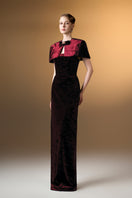 Dark red strapless column gown with mini cape in grain velvet by I.H.F, featuring a sleek silhouette and elegant design.