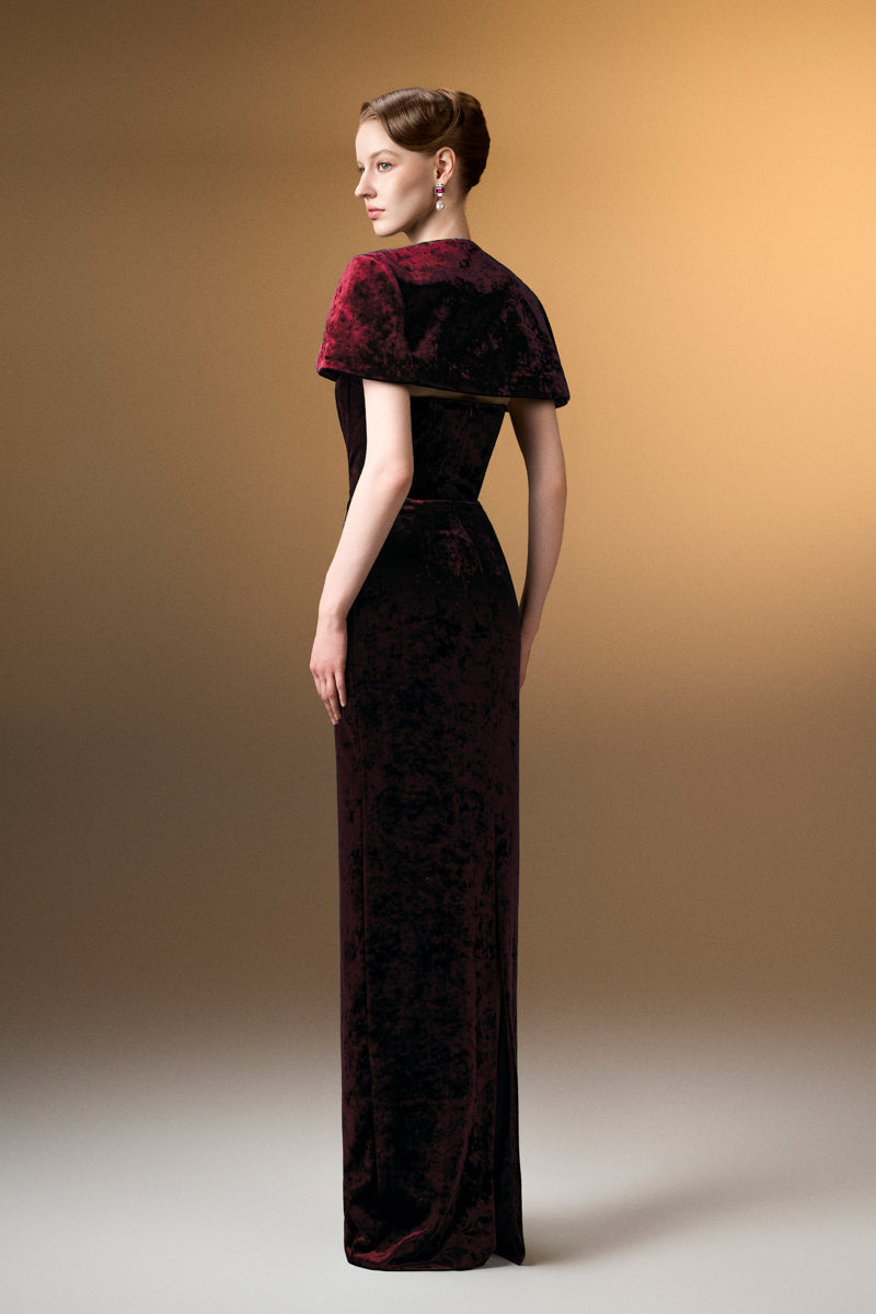 Dark red strapless column gown with mini cape in grain velvet by I.H.F, showcasing elegant design and luxurious fabric.