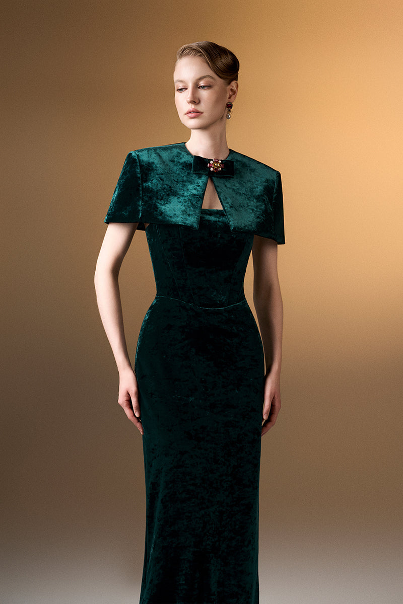 Green strapless column gown with mini cape in grain velvet by I.H.F, featuring a sleek silhouette and elegant design.