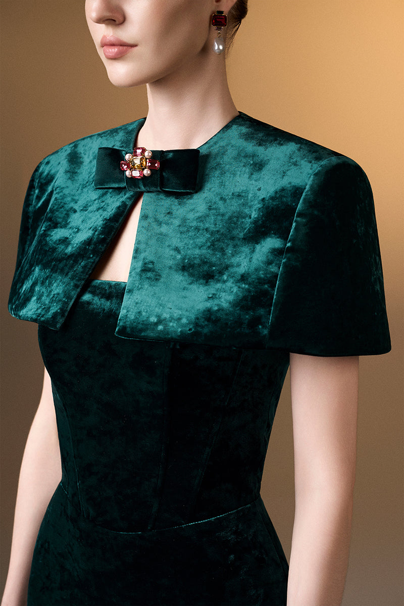 Green strapless column gown with a mini cape in grain velvet by I.H.F, shown on a model with elegant styling.