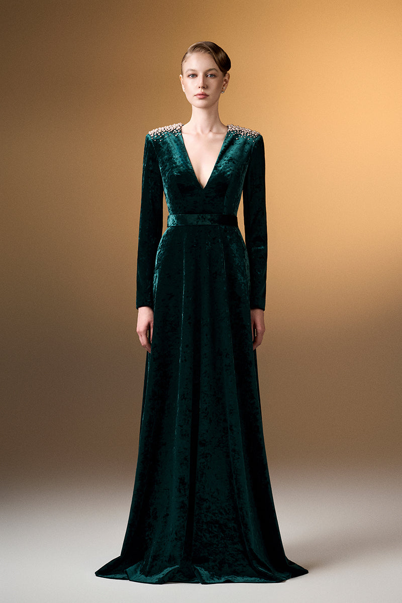 Green V-neck A-line gown with long sleeves in grain velvet by I.H.F, shown on a model with a flowing silhouette.