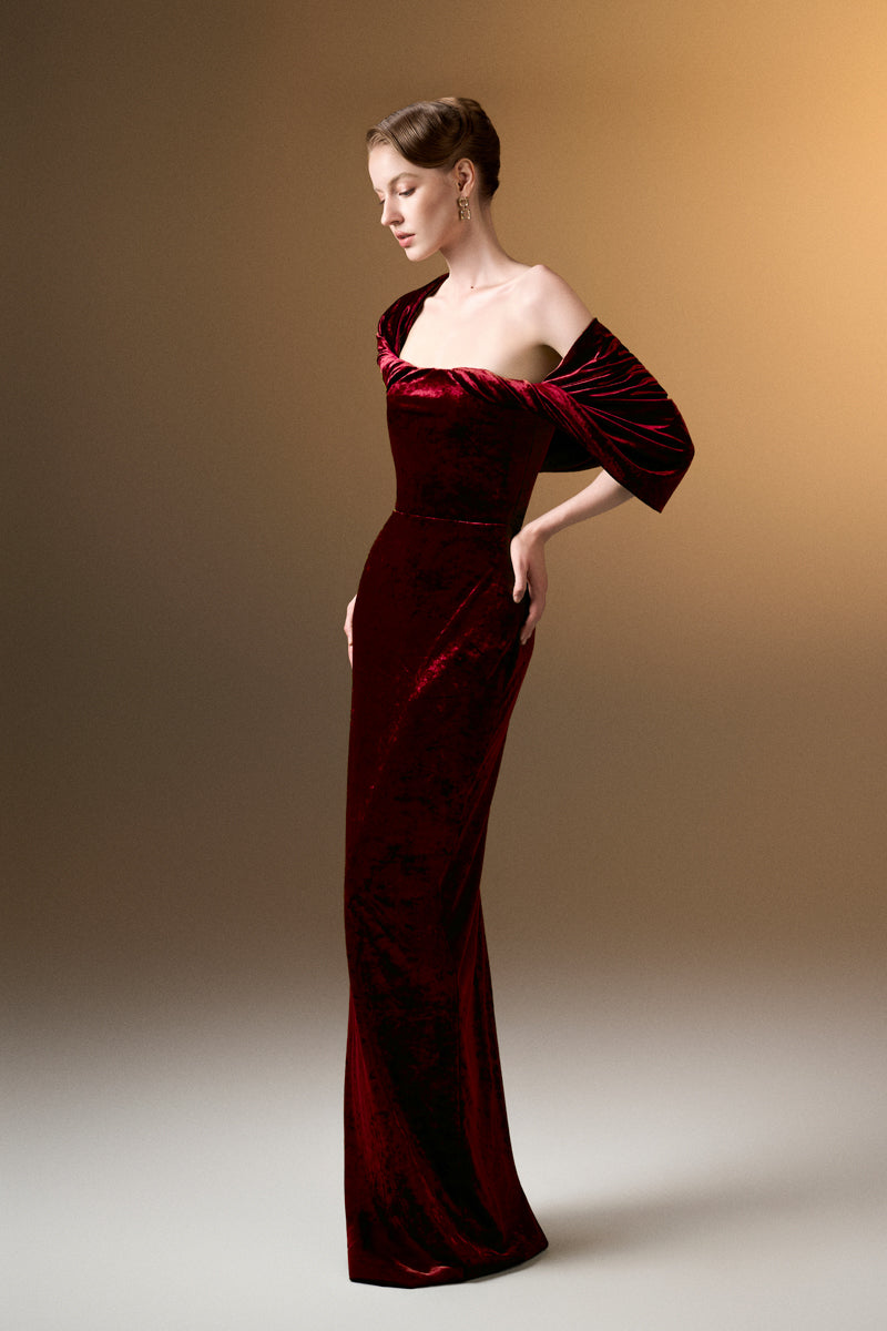 Dark red strapless column gown with pleated sleeves in grain velvet by I.H.F, showcasing elegant fabric and sleek silhouette.
