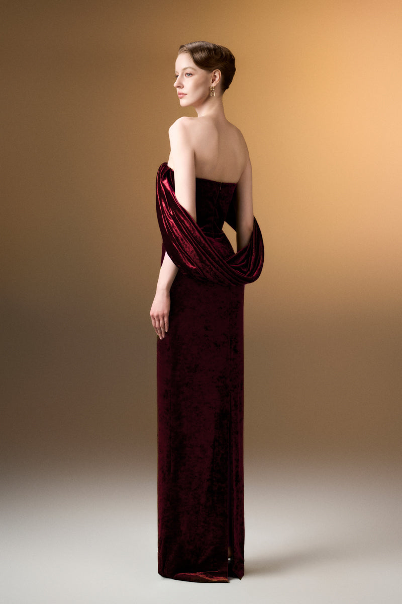 Dark red strapless column gown with pleated sleeves in grain velvet by I.H.F, shown on a model.