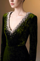 Green V-neck column gown with long sleeves in grain velvet by I.H.F, featuring a sleek, elegant silhouette.
