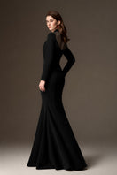 Black draped crepe mermaid gown by I.H.F with round neckline and elegant fit, shown on a model.