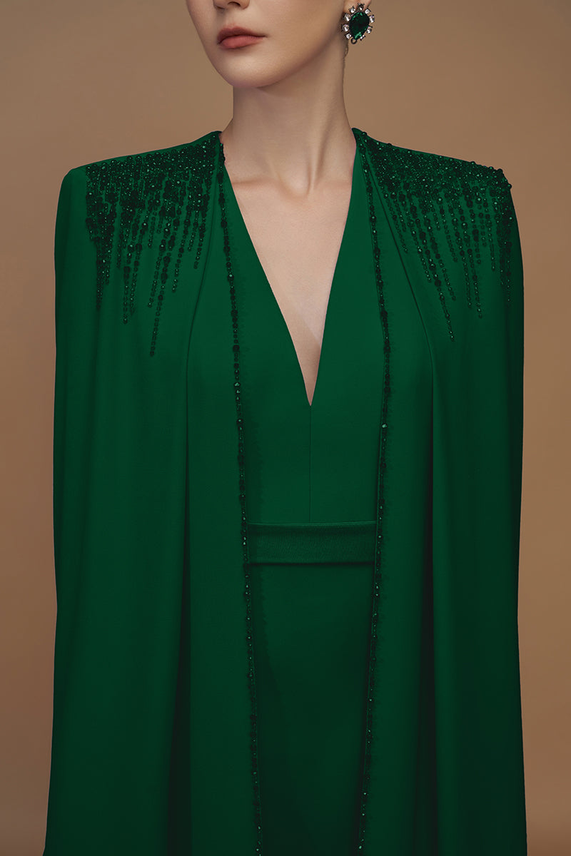 Emerald green crepe and silk taffeta gown by I.H.F, featuring a flowing cape and elegant design, perfect for formal occasions.