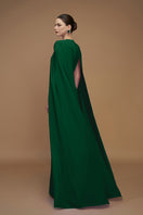 Elegant emerald gown with crepe and silk taffeta, designed by I.H.F, featuring a flowing silhouette and intricate detailing.