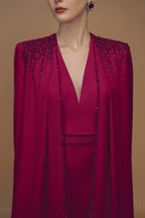 Elegant I.H.F crepe and silk taffeta cape lipstick gown displayed in a luxurious evening gown with flowing fabric and sophisticated design.