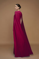 Elegant crepe and silk taffeta cape lipstick gown by I.H.F, featuring flowing fabric and sophisticated design.