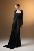 Black trapeze neck column gown by I.H.F in guipure lace and taffeta, featuring a sleek silhouette and elegant design.