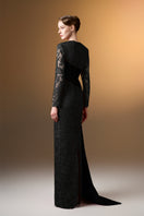 Black trapeze neck column gown in guipure lace and taffeta by I.H.F, shown on a model with elegant draping and intricate lace details.