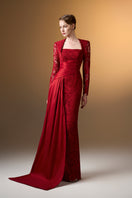 Red trapeze neck column gown by I.H.F in dark guipure lace and taffeta, shown on a model with elegant draping details.