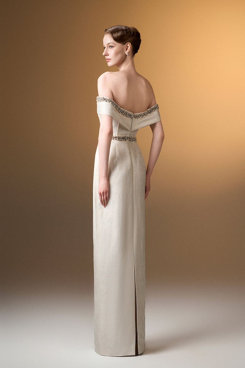 Ivory off-shoulder column gown with rose design brocade by I.H.F, elegant evening dress with intricate floral pattern.