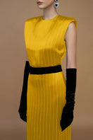 Yellow striped silk gown by I.H.F displayed on a mannequin with flowing fabric and elegant design.