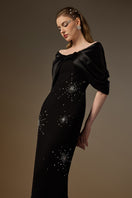 Elegant black draped V-neck column gown by I.H.F featuring crepe and satin silk fabric, showcasing a sleek silhouette.