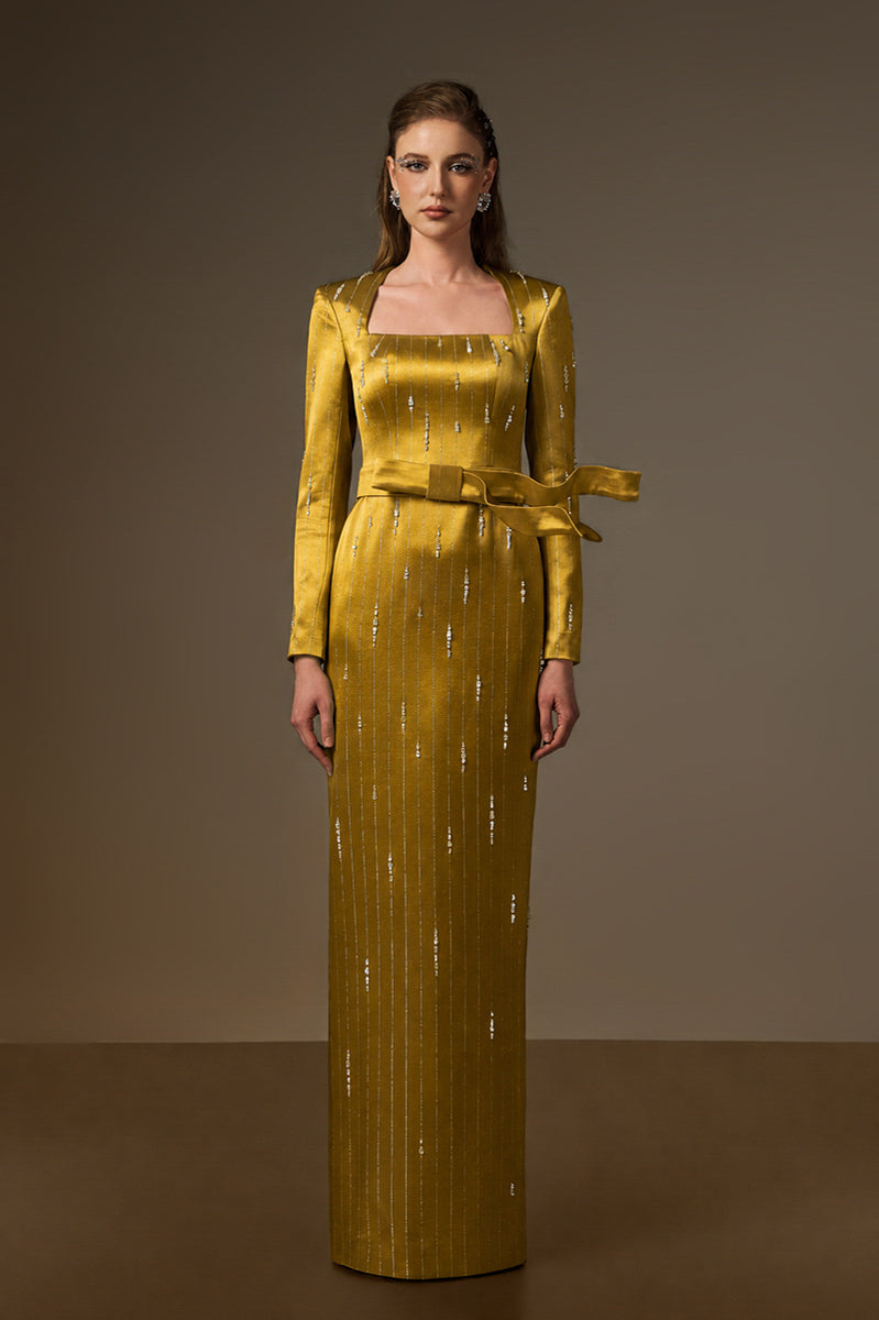 Yellow metallic belted Marisol gown by I.H.F featuring a trapeze neck and wind-blown train design in stripped silk.