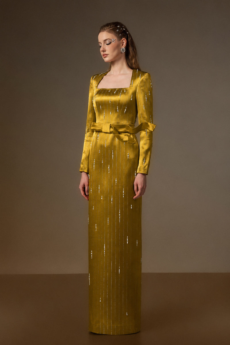 Yellow metallic belted train column gown by I.H.F, featuring a trapeze neck and wind-blown style in shimmering silk fabric.