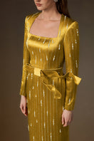 Yellow metallic belted train column gown by I.H.F featuring a trapeze neck and wind-blown silk train design.