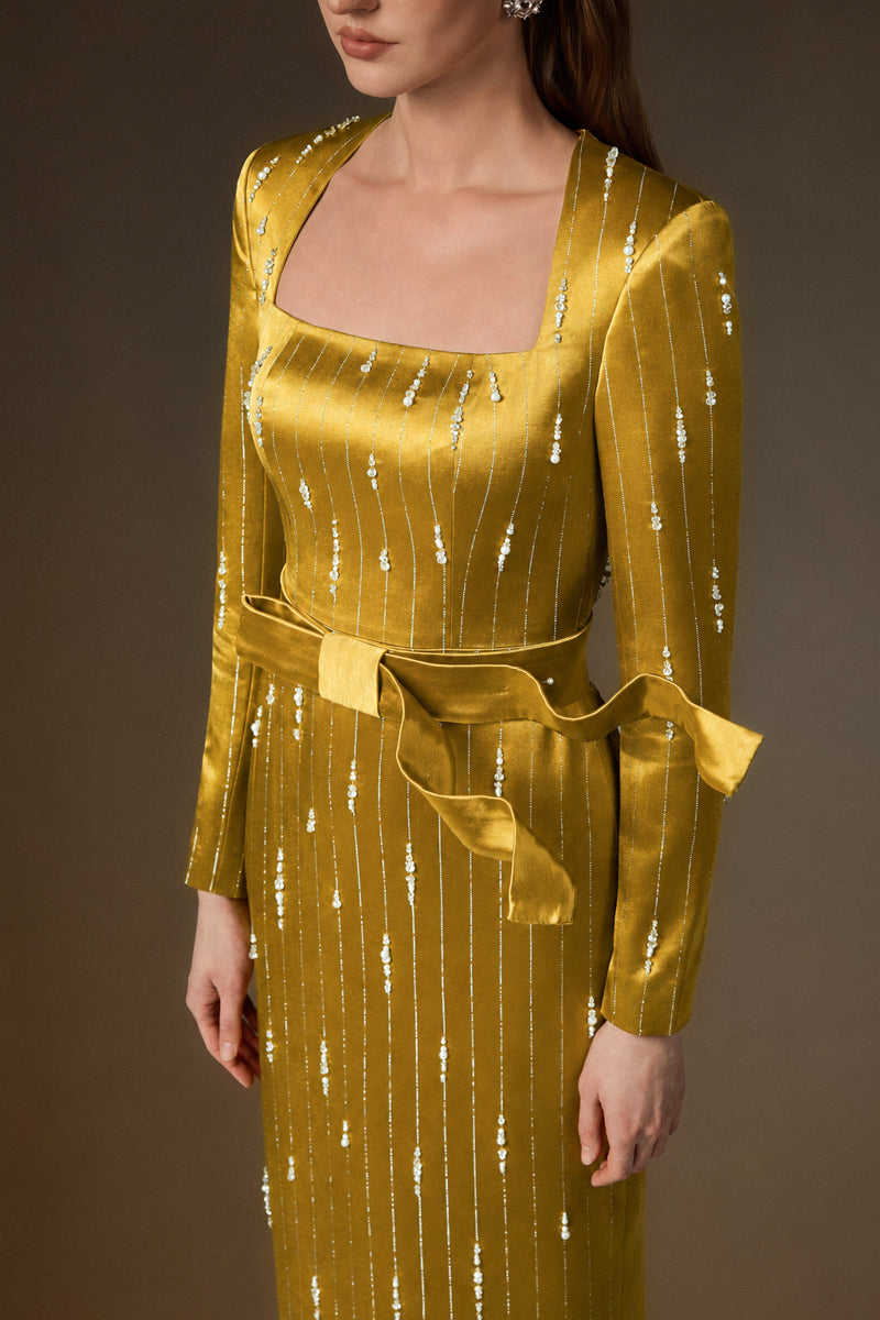 Yellow metallic belted train column gown by I.H.F featuring a trapeze neck and wind-blown silk train design.