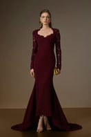 Elegant burgundy mermaid gown with trapeze neckline, floral garden mesh lace, and mullet hem, designed by I.H.F.