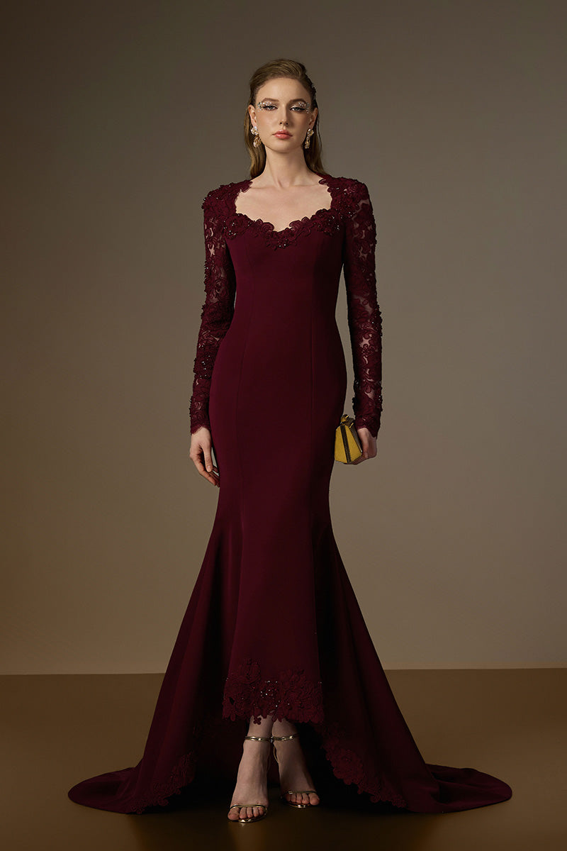 Elegant burgundy mermaid gown with trapeze neckline, floral garden mesh lace, and mullet hem, designed by I.H.F.