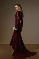I.H.F Margaix burgundy mermaid gown with trapeze neck, floral garden mesh lace, and mullet hem, displayed on a hanger.