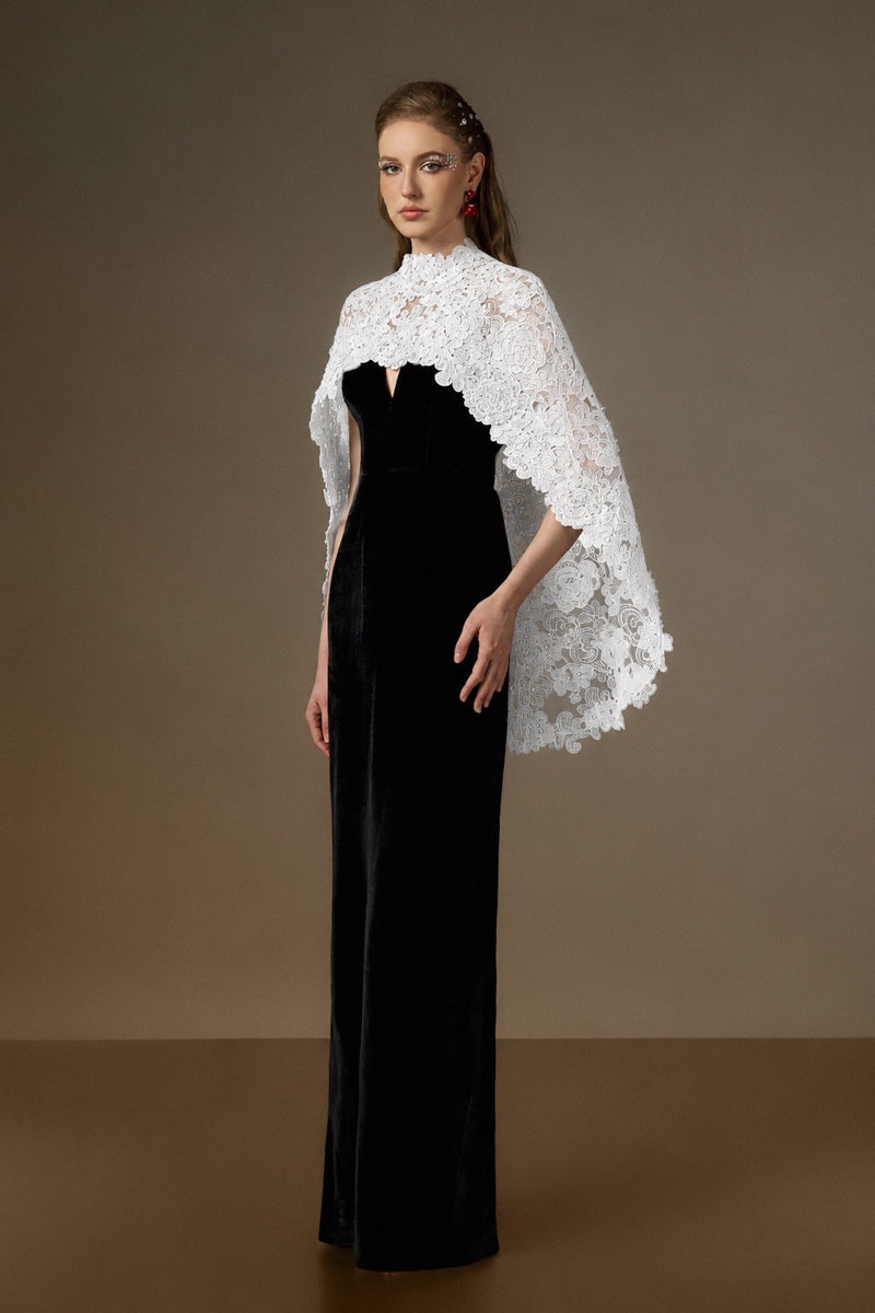 Black and white V-neck caped column gown by I.H.F featuring velvet fabric and floral garden mesh lace detailing.